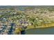Aerial view of community, showcasing homes, lake, and surrounding landscape at 2811 Sonata Ct, St Cloud, FL 34772