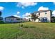 Large backyard with two-story house and green lawn at 2811 Sonata Ct, St Cloud, FL 34772