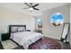 Bedroom with queen bed, circular window and area rug at 2811 Sonata Ct, St Cloud, FL 34772