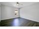 Simple bedroom with dark wood floors and a ceiling fan at 2811 Sonata Ct, St Cloud, FL 34772