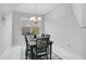 Bright dining room with chandelier and seating for six at 2811 Sonata Ct, St Cloud, FL 34772