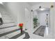Bright entryway with marble-look flooring and modern staircase at 2811 Sonata Ct, St Cloud, FL 34772