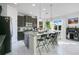 Modern kitchen with granite countertops, island, and dark wood cabinets at 2811 Sonata Ct, St Cloud, FL 34772