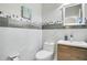 Modern powder room with wood vanity and marble-look tile at 2811 Sonata Ct, St Cloud, FL 34772