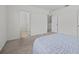 Spacious bedroom with carpeted floor, light blue comforter and an ensuite bathroom at 355 Highcrest Rd, Davenport, FL 33896