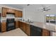Kitchen with dark wood cabinets and black appliances and lake view at 355 Highcrest Rd, Davenport, FL 33896