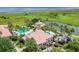 Aerial view of the community pool and surrounding landscape, overlooking the lake at 3634 Northwoods Dr, Kissimmee, FL 34746