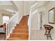 Two-story entryway with wood staircase and tile flooring at 4603 Cumbrian Lakes Dr, Kissimmee, FL 34746