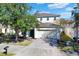 Two-story house with a large driveway and well-maintained lawn at 4603 Cumbrian Lakes Dr, Kissimmee, FL 34746