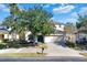 Two-story house with green door and driveway at 4603 Cumbrian Lakes Dr, Kissimmee, FL 34746