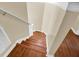 Indoor staircase with wood flooring and white railings at 4603 Cumbrian Lakes Dr, Kissimmee, FL 34746