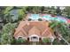 Community clubhouse with tile roof, near pool and tennis courts at 4731 Hemingway House St, Kissimmee, FL 34746