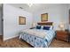 Bedroom with wood flooring and coastal bedding at 504 Terrace Ridge Cir # 311, Davenport, FL 33896