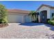 Two-car garage with paver driveway and lush landscaping at 506 Santavita Pl, Poinciana, FL 34759