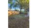 Large backyard with a wooden fence and mature shade tree at 5413 Vanderlin St, Orlando, FL 32810