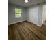 Spacious bedroom with wood flooring and a double door closet at 5413 Vanderlin St, Orlando, FL 32810