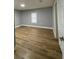 Bright bedroom with wood-look floors and neutral wall colors at 5413 Vanderlin St, Orlando, FL 32810
