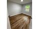 Bright bedroom with wood-look floors and a window at 5413 Vanderlin St, Orlando, FL 32810