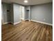 Spacious bedroom with wood-look floors and access to a bathroom at 5413 Vanderlin St, Orlando, FL 32810