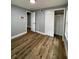 Spacious bedroom with wood-look floors and neutral wall colors at 5413 Vanderlin St, Orlando, FL 32810