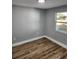 Bright bedroom featuring wood-look flooring and neutral gray walls at 5413 Vanderlin St, Orlando, FL 32810