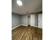Well-lit bedroom with wood-look floors and ample closet space at 5413 Vanderlin St, Orlando, FL 32810