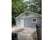 Gray detached garage with white door and window at 5413 Vanderlin St, Orlando, FL 32810