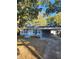 Newly renovated home with gray siding, landscaping, and a carport at 5413 Vanderlin St, Orlando, FL 32810