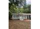 Newly renovated home with gray siding, landscaping, and a carport at 5413 Vanderlin St, Orlando, FL 32810