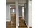 Bright hallway with wood-look floors, leading to bedrooms at 5413 Vanderlin St, Orlando, FL 32810
