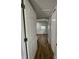 Bright hallway with wood flooring leads to bedrooms at 5413 Vanderlin St, Orlando, FL 32810