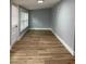 Bright room with wood-look floors and large window at 5413 Vanderlin St, Orlando, FL 32810