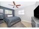 Spacious bedroom with a queen bed and ceiling fan at 5804 Defiance Ave, Orlando, FL 32839