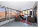 Cozy screened porch with wicker furniture and red accent pillows at 5804 Defiance Ave, Orlando, FL 32839