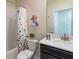 Stylish bathroom with tub shower, vanity, and polka dot curtain at 691 Drop Shot Dr, Davenport, FL 33896