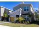 Modern two-story house with a yellow garage door and landscaping at 691 Drop Shot Dr, Davenport, FL 33896