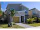 Contemporary home with gray siding and a paved driveway at 691 Drop Shot Dr, Davenport, FL 33896