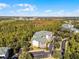 Aerial perspective of a residential building, highlighting its location within a tree-lined community at 9051 Treasure Trove Ln # 207, Kissimmee, FL 34747