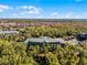 An aerial view showcasing a residential building nestled amongst trees, offering a tranquil setting at 9051 Treasure Trove Ln # 207, Kissimmee, FL 34747