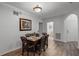 Dining area with a wooden table and chairs, view of bathroom at 9051 Treasure Trove Ln # 207, Kissimmee, FL 34747