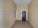 Private condo entryway with a black door and a small window at 9051 Treasure Trove Ln # 207, Kissimmee, FL 34747