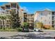 Exterior view of a condo building showcasing the architectural design and landscaping at 9051 Treasure Trove Ln # 207, Kissimmee, FL 34747