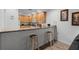 Kitchen with light wood cabinets and a breakfast bar at 9051 Treasure Trove Ln # 207, Kissimmee, FL 34747