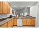 Kitchen features wood cabinets, granite countertops, and a dishwasher at 9051 Treasure Trove Ln # 207, Kissimmee, FL 34747