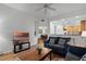 Open living room with gray sofas and view into kitchen and dining areas at 9051 Treasure Trove Ln # 207, Kissimmee, FL 34747