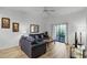Living room with gray sofa, coffee table, and access to a balcony at 9051 Treasure Trove Ln # 207, Kissimmee, FL 34747