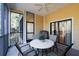 Screened porch with seating and ceiling fan at 9051 Treasure Trove Ln # 207, Kissimmee, FL 34747