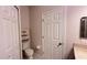 Clean bathroom with a toilet and a door at 9536 Muse Pl, Orlando, FL 32829