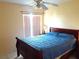 Bedroom with a queen-size bed and ceiling fan at 101 Whitehall Way, Kissimmee, FL 34758