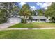 Ranch-style home with attached garage, mature landscaping, and spacious lawn at 119 Candlewick Rd, Altamonte Springs, FL 32714